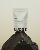 Naere product packaging on a rock with a beige background